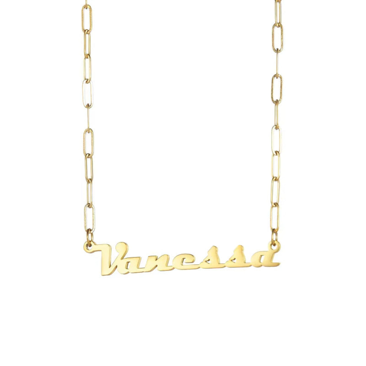 Close-up of gold name necklace on black surface