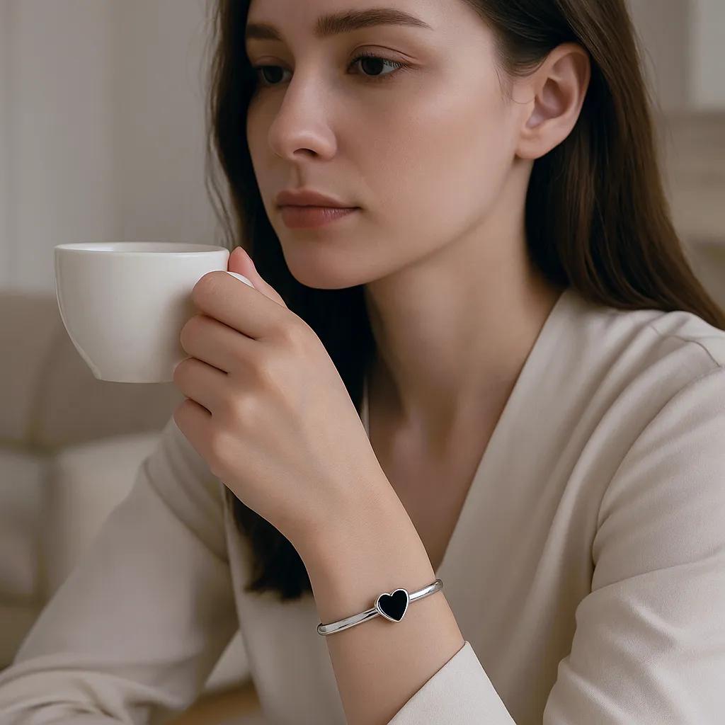 Sterling silver heart cuff bracelet shown from top view on wrist
