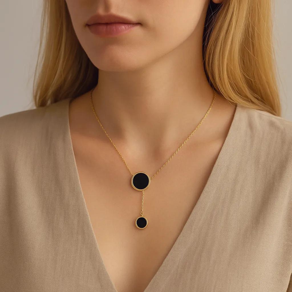 Minimalist black enamel circle pendant necklace in gold finish – flat lay