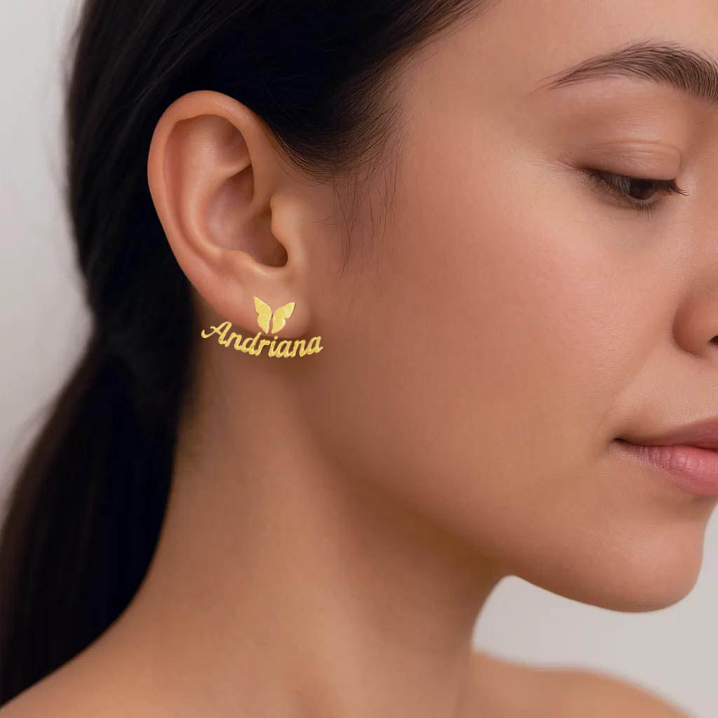 Close-up of personalized earrings showing butterfly and name