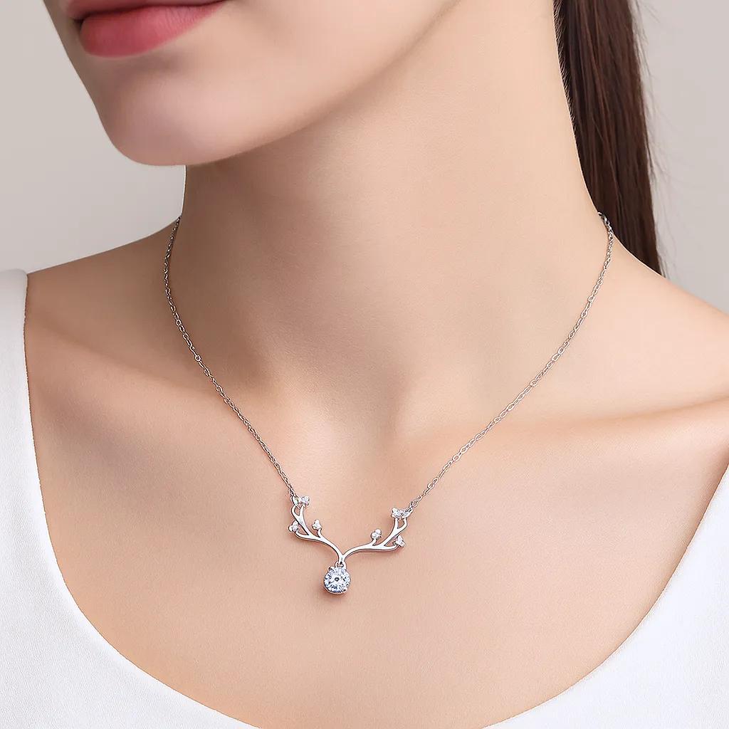  Elegant necklace with antler design and central gem.