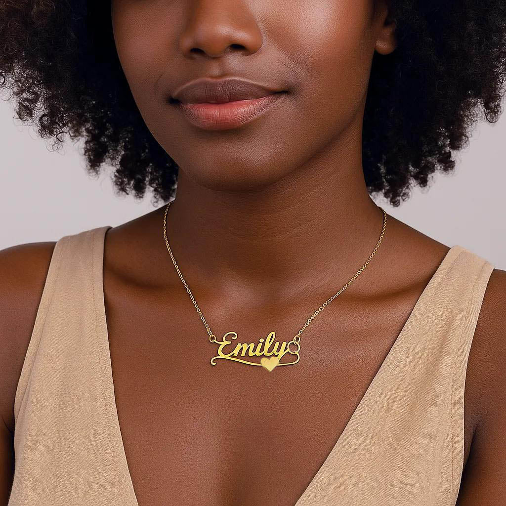 Close-up of gold necklace showing name and heart design.