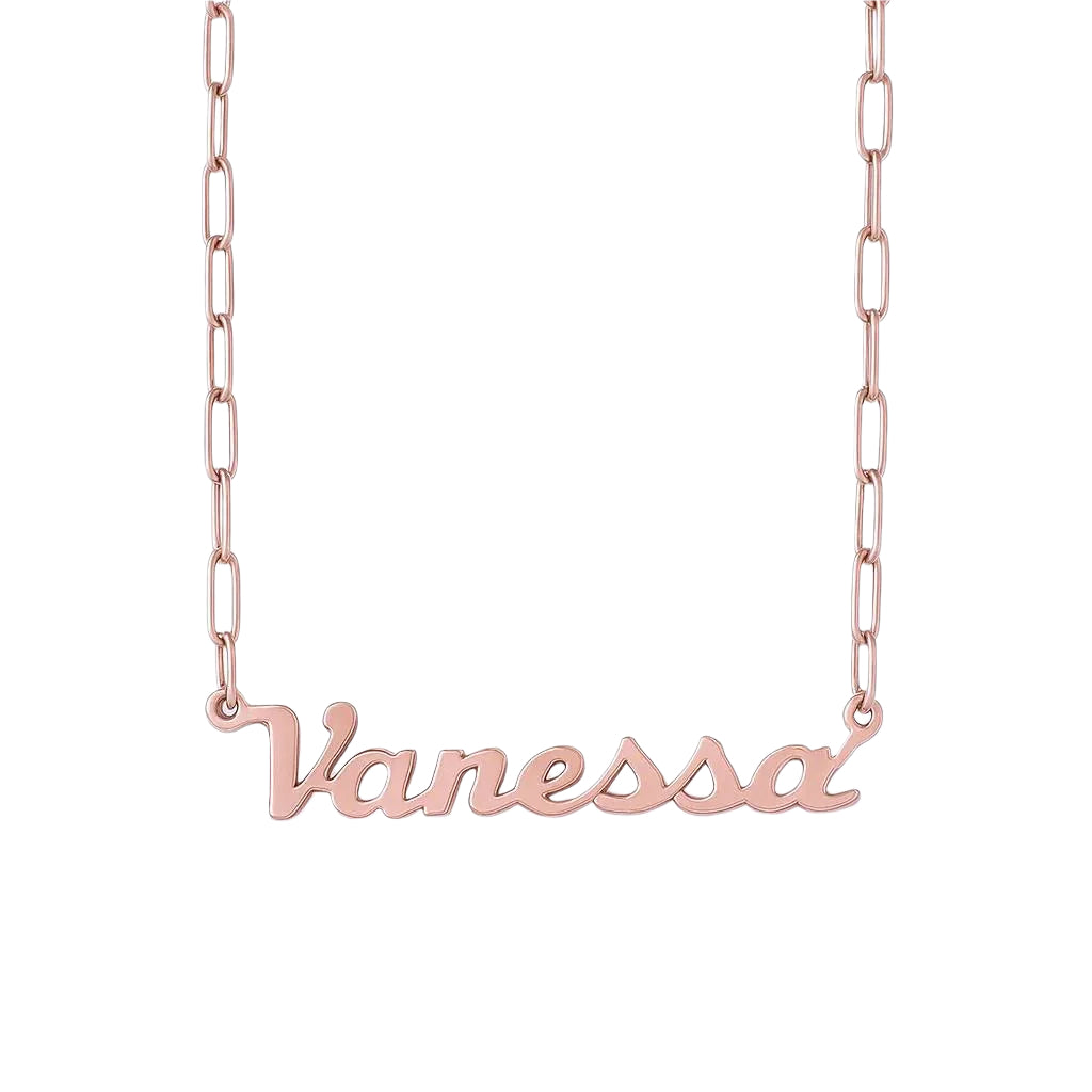 Close-up of rose gold name necklace on black surface.