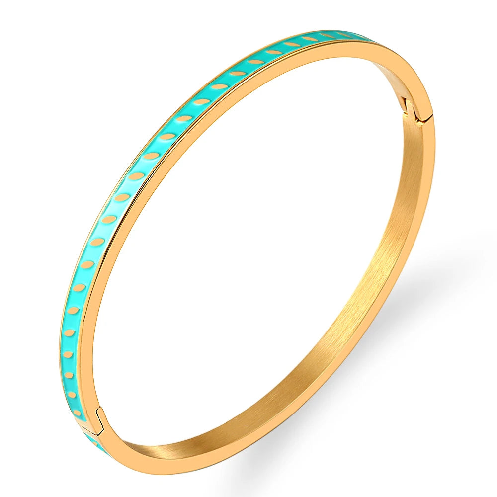 Gold bangle with turquoise band on a white background