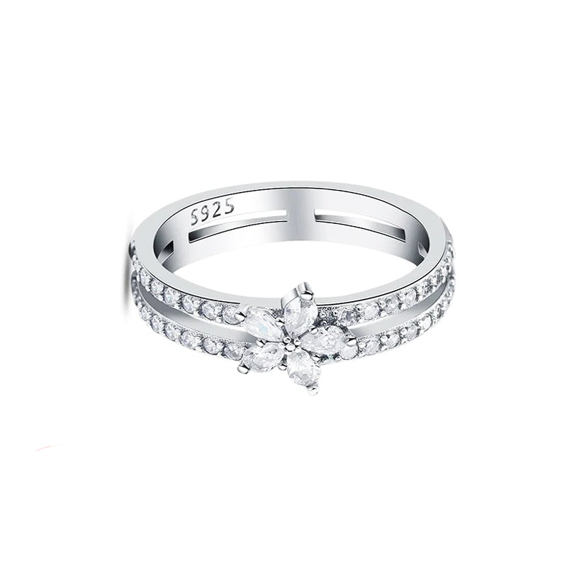 Silver ring with floral design and '925' stamp on a white background