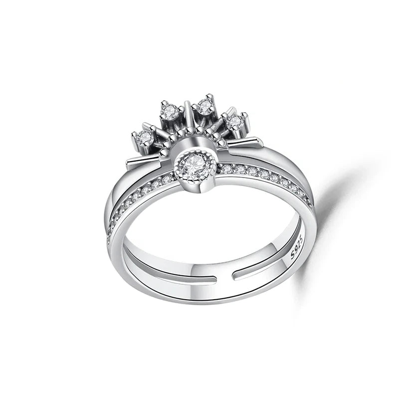 Silver ring with diamond accents on a white background