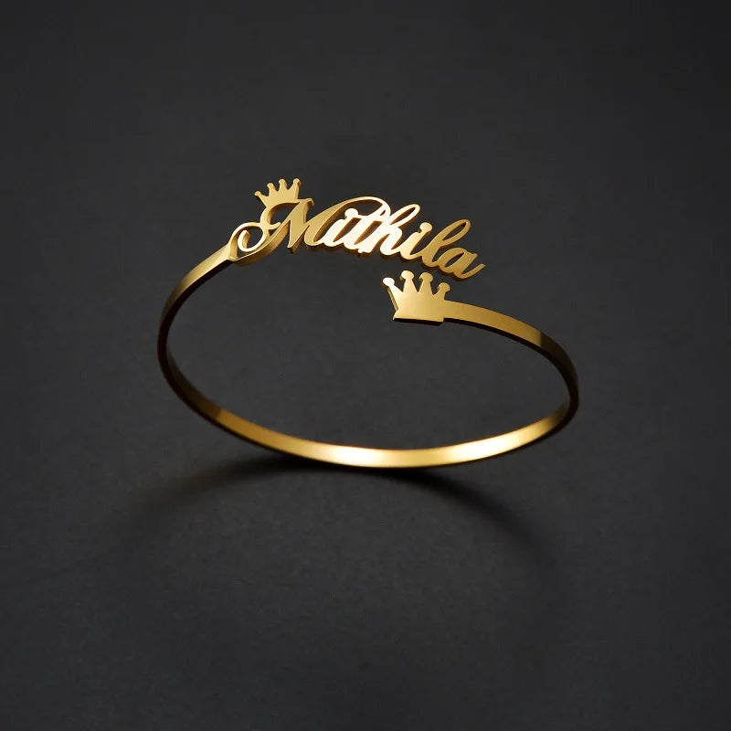 Gold bracelet with 'Mithila' engraving on a dark background
