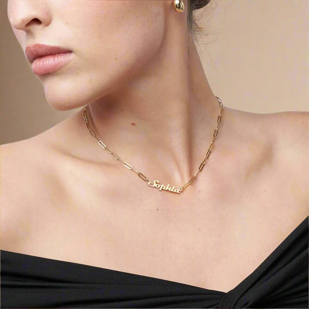 Side view of elegant gold chain and name pendant.