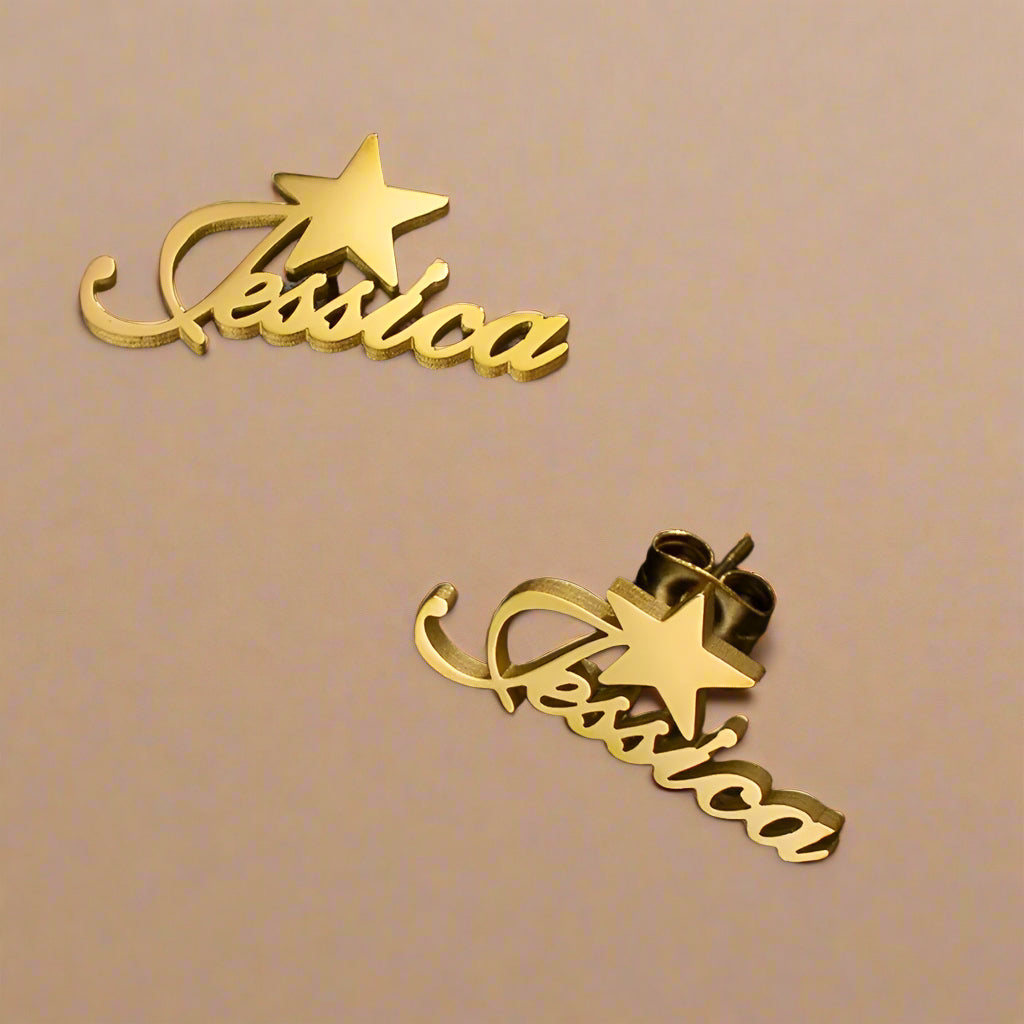 Close-up of gold earrings with personalized text and star.