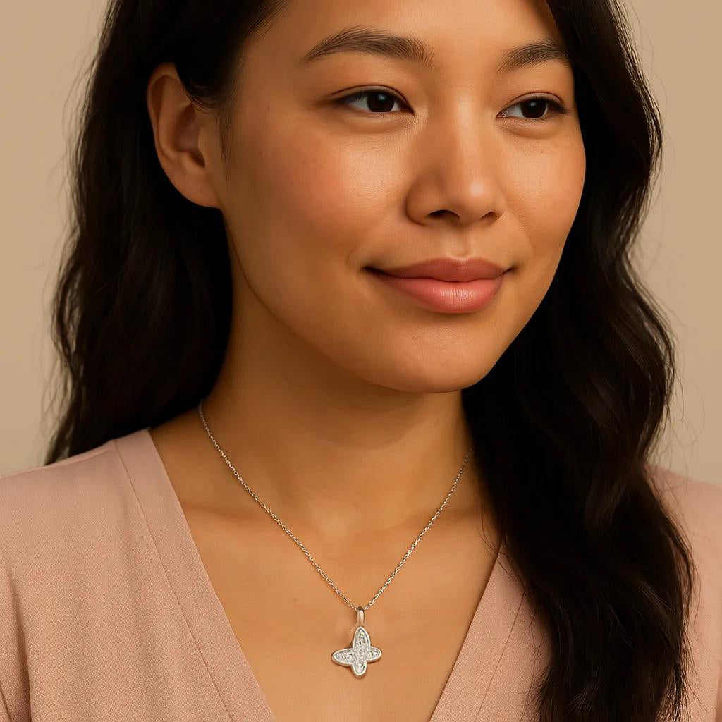 Woman wearing a butterfly pendant necklace against a beige background