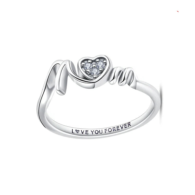 Silver ring with heart-shaped gem and 'Love You Forever' engraving on a white background