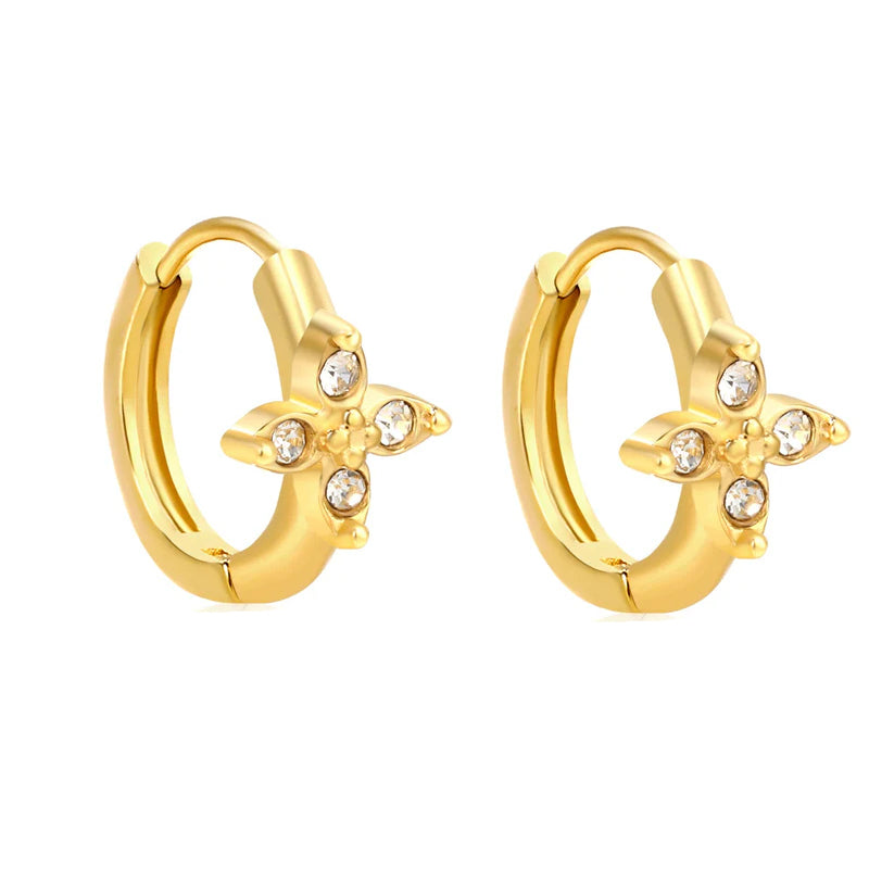 Gold hoop earrings with floral designs and small crystals on a white background