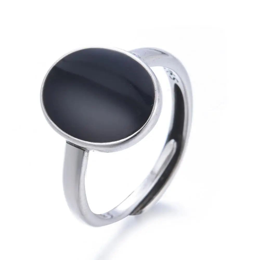 Close-up of modern oval resin ring against white background