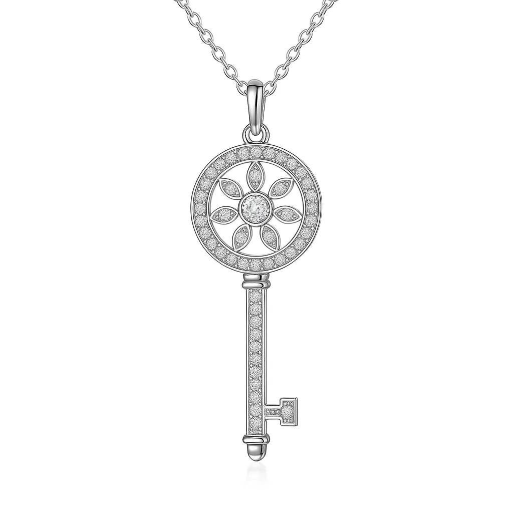 Silver key-shaped pendant with floral design on a white background