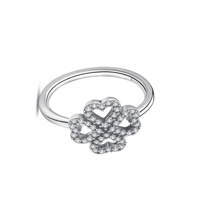 Silver ring with a floral design on a white background