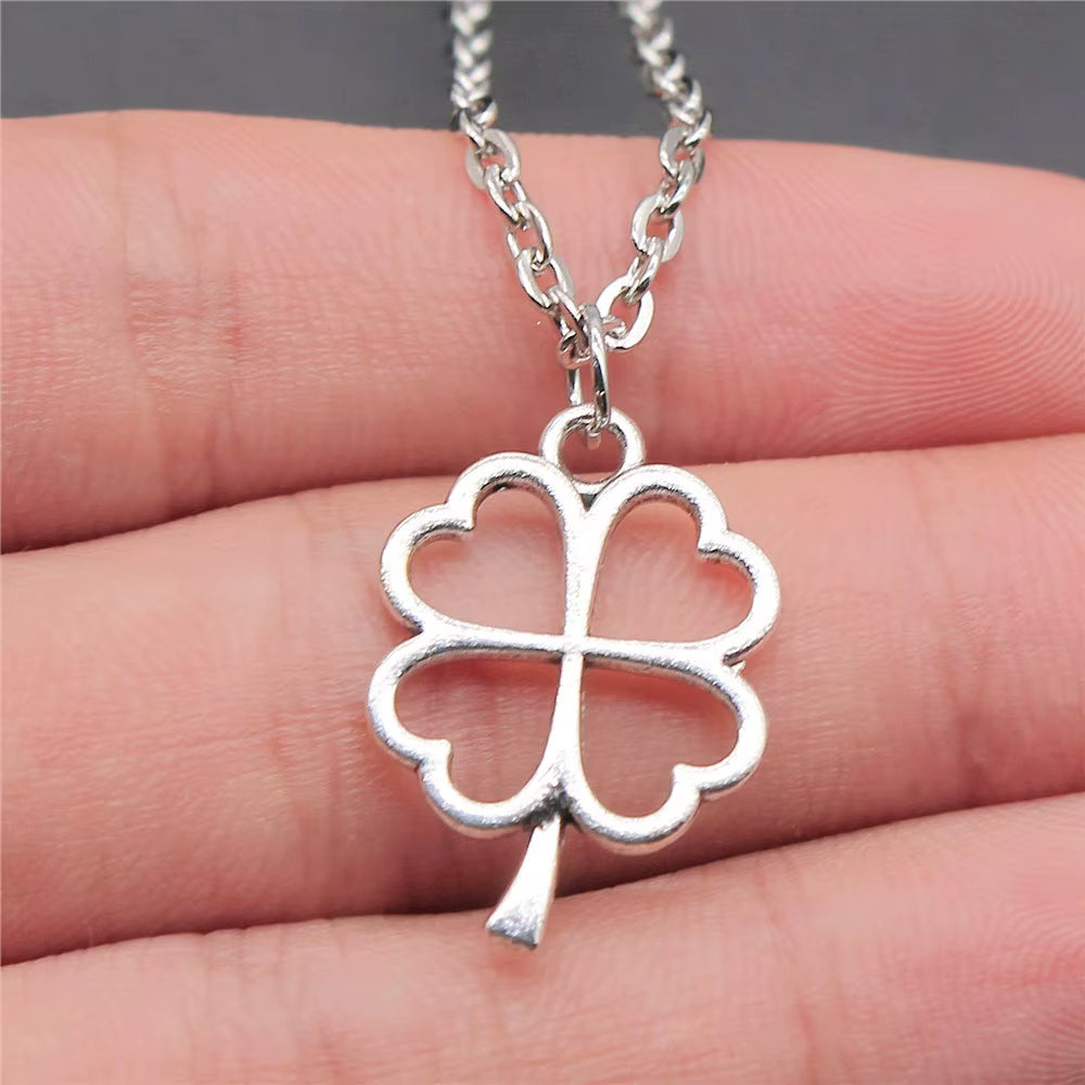 Elegant silver necklace with clover design charm.