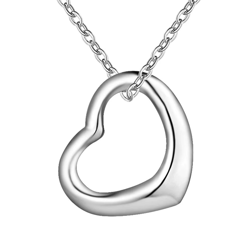 Gold heart pendant on a silver chain with blue background.