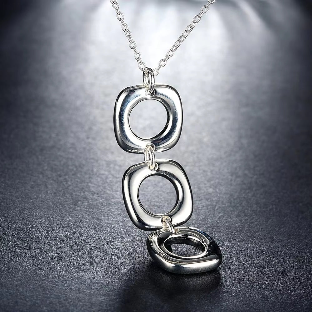  Elegant necklace with three interlocked silver squares.