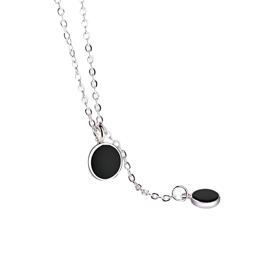 Minimalist black enamel circle pendant necklace in gold finish – flat lay
