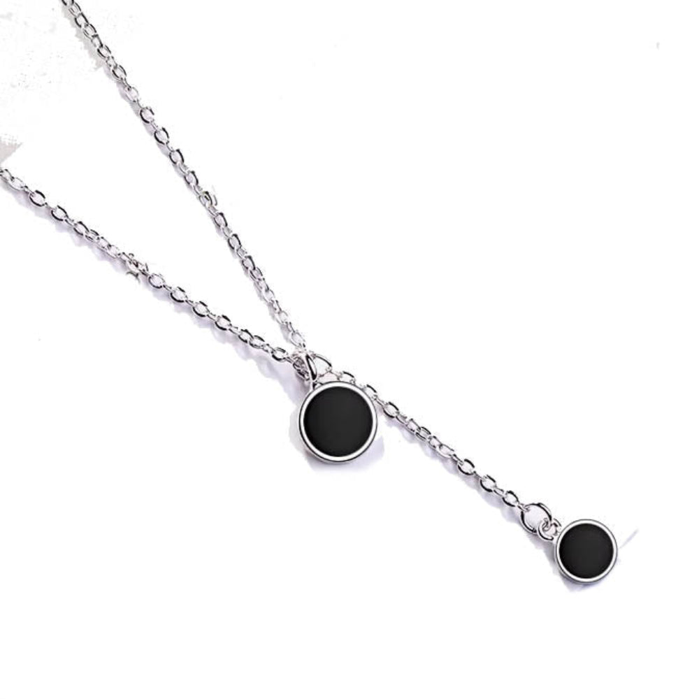 Minimalist black enamel circle pendant necklace in gold finish – flat lay