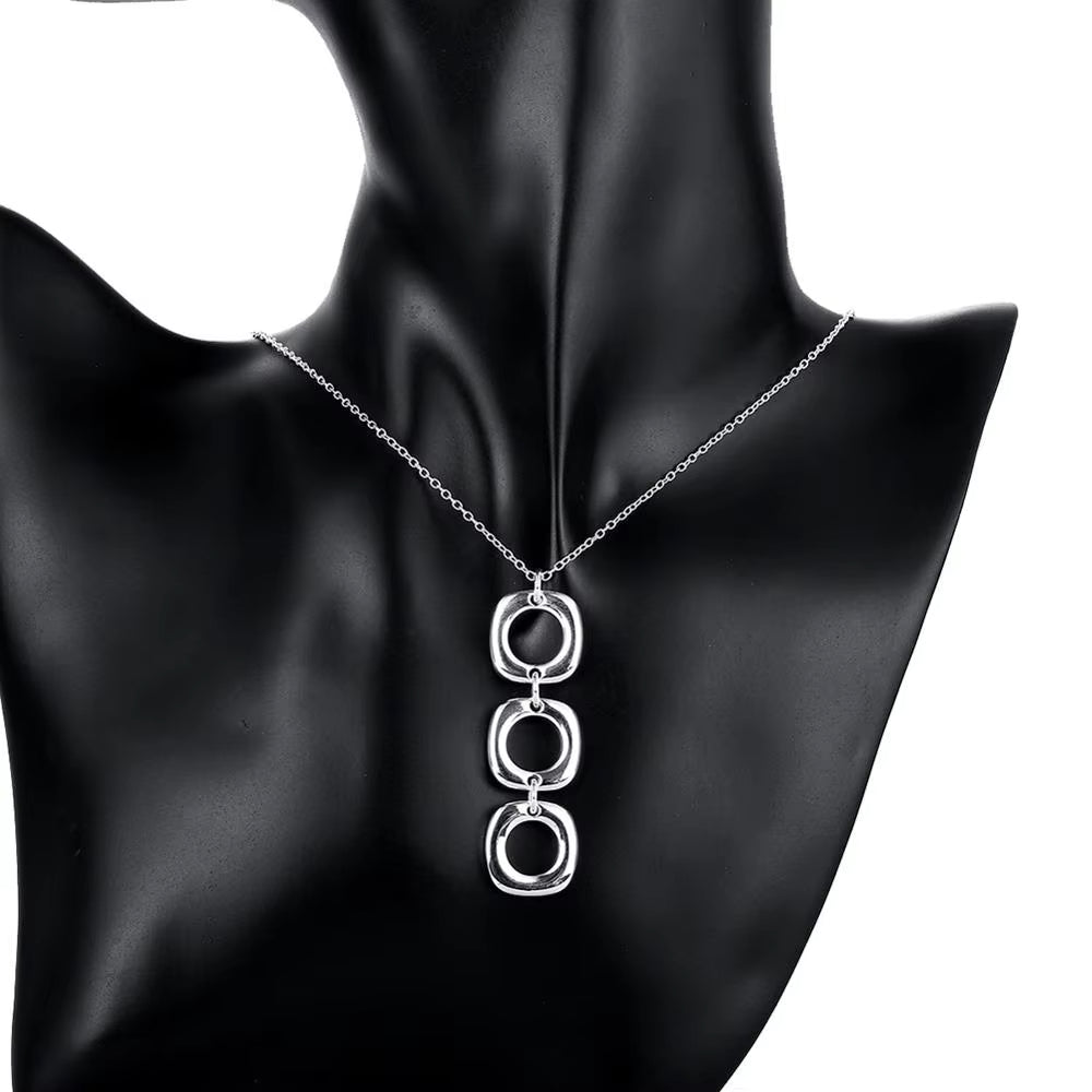  Elegant necklace with three interlocked silver squares.
