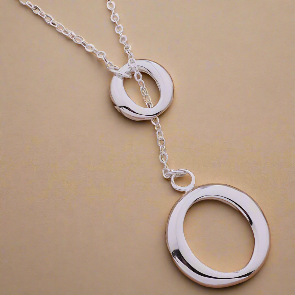 Stylish silver pendant necklace displayed elegantly.