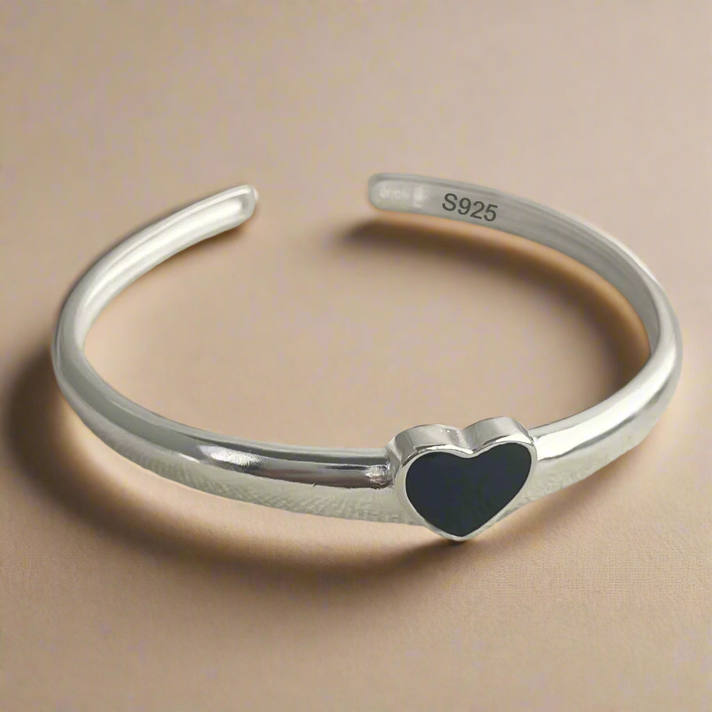 Gift-ready silver bangle with bold heart detail for women