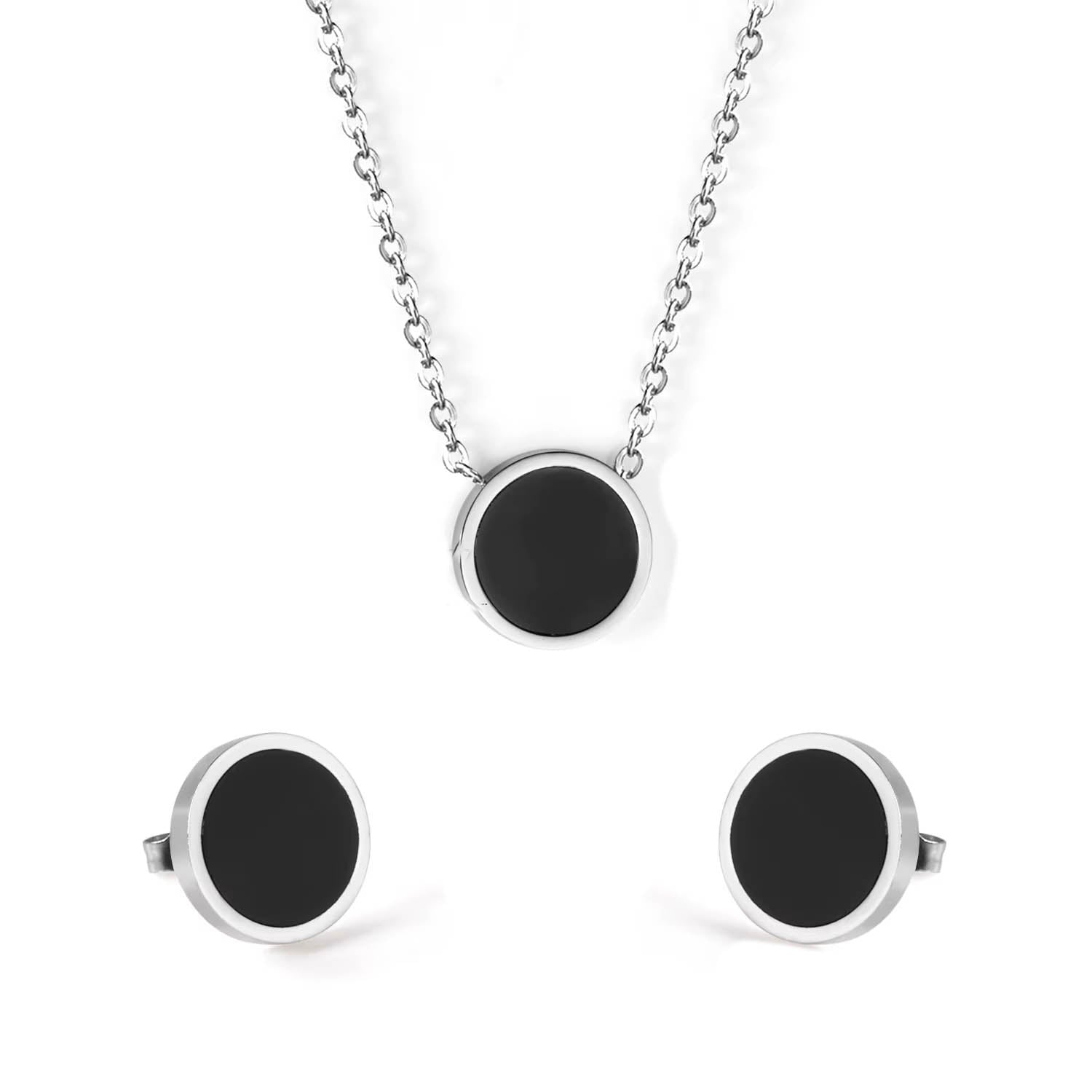 Close-up of black and gold geometric jewelry on soft silver fabric