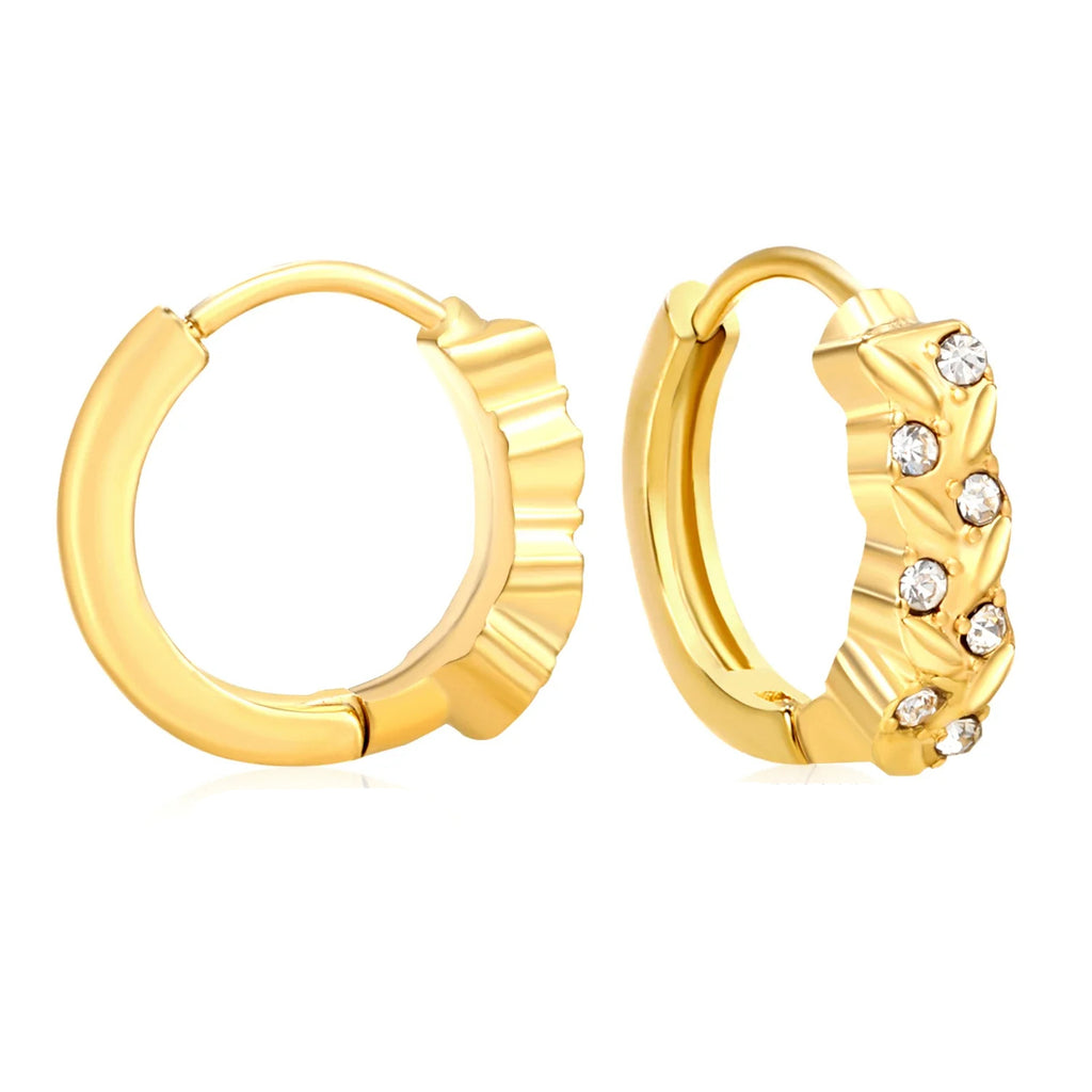 Gold hoop earrings with one having gemstone accents on a white background