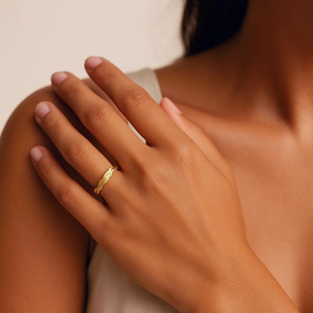 Elegant gold cuff bracelet showcasing intricate weave design.