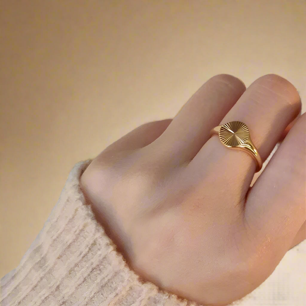 Minimalist gold ring on a white background.  