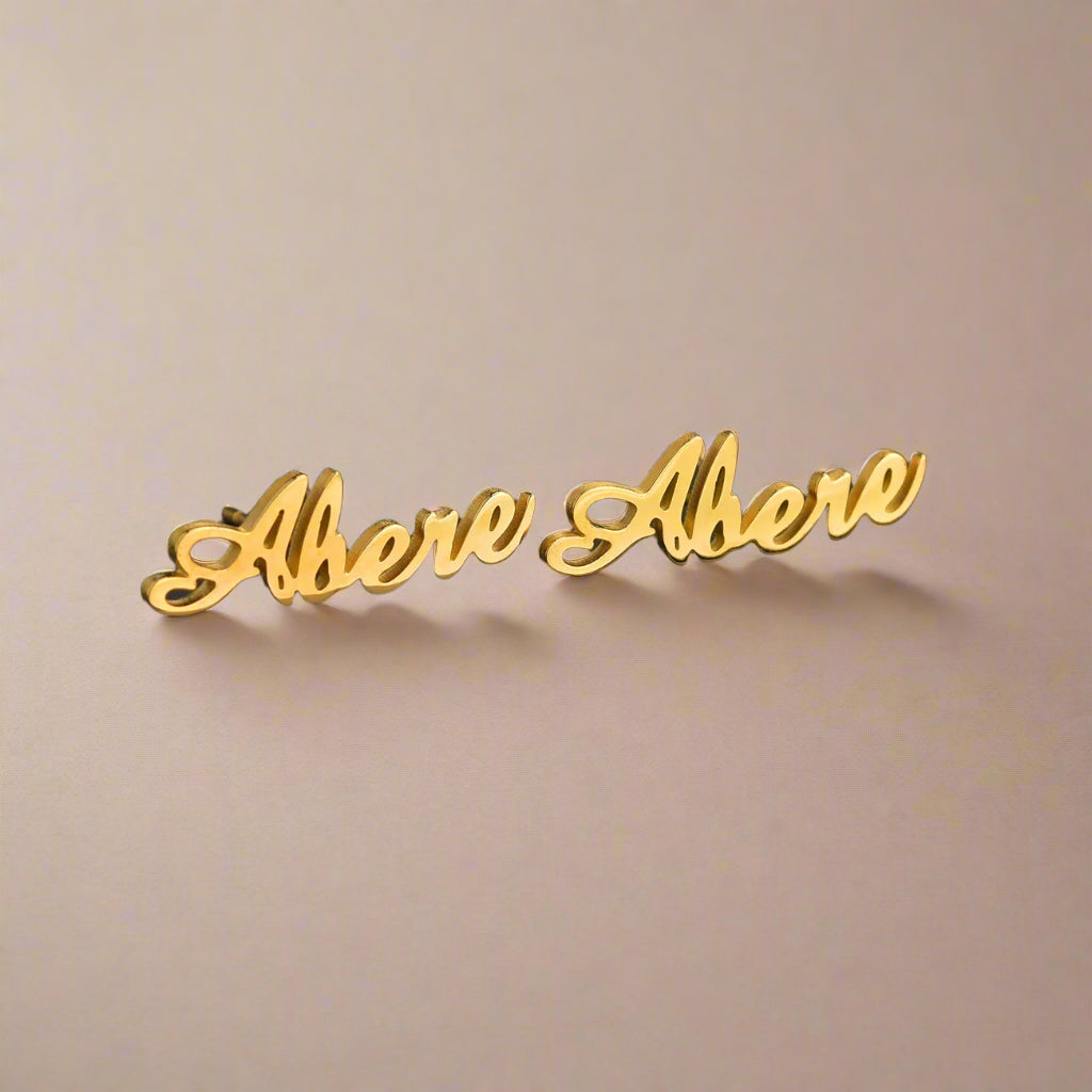 Close-up of personalized gold earrings.