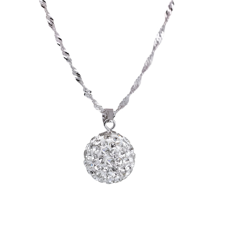 Silver necklace with a round, sparkling pendant on a soft pink background