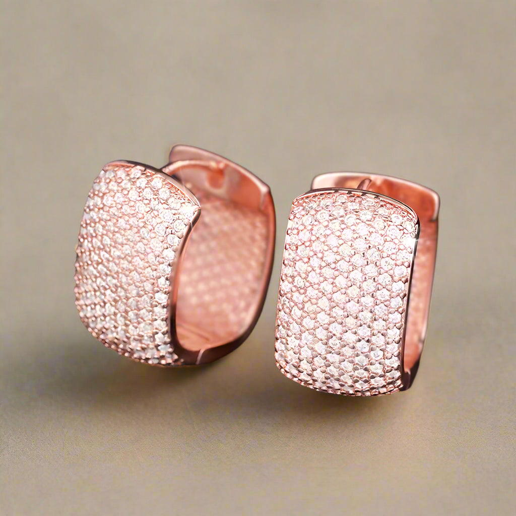 Close-up of silver and gold cubic zirconia earrings