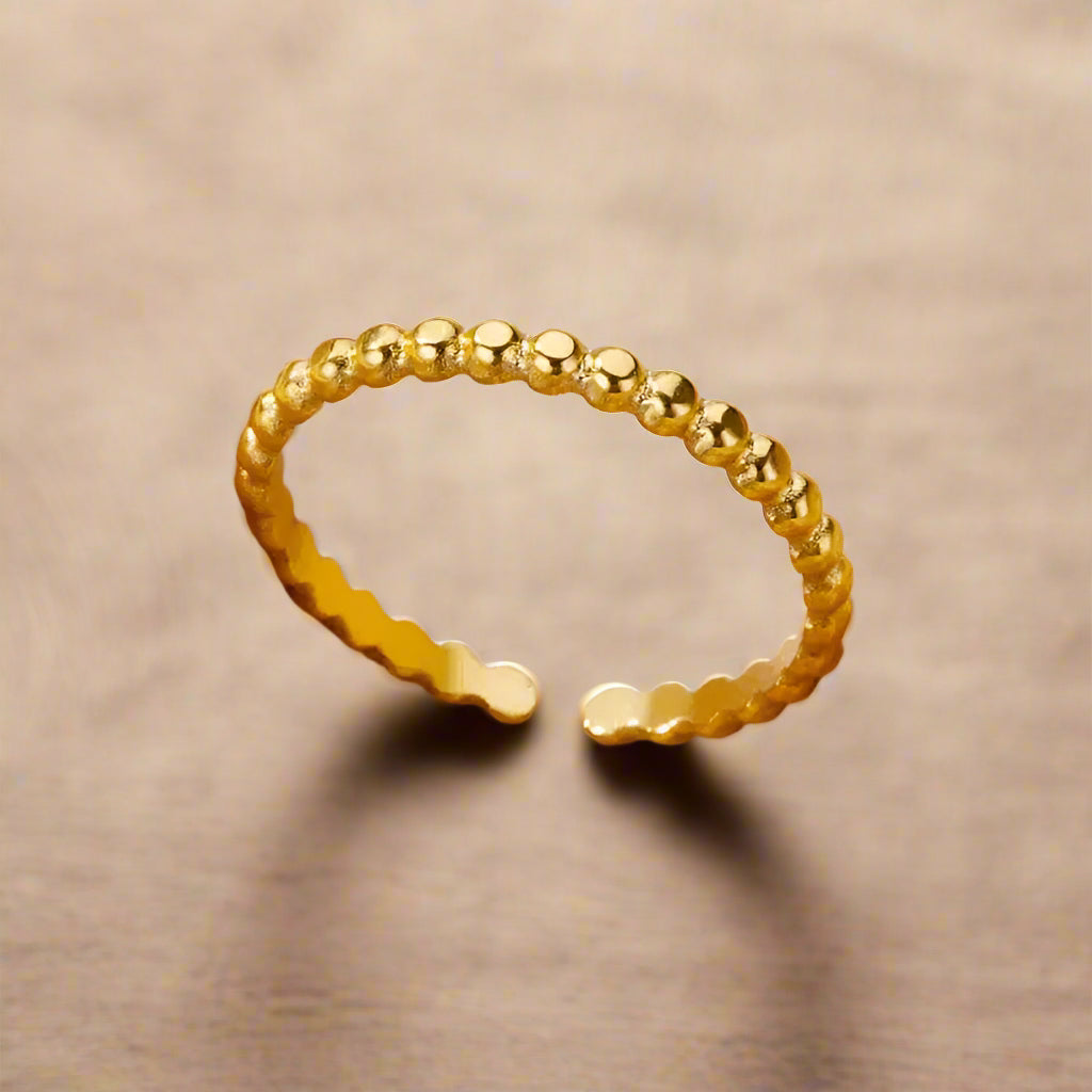 Side view of gold-plated, beaded open ring.