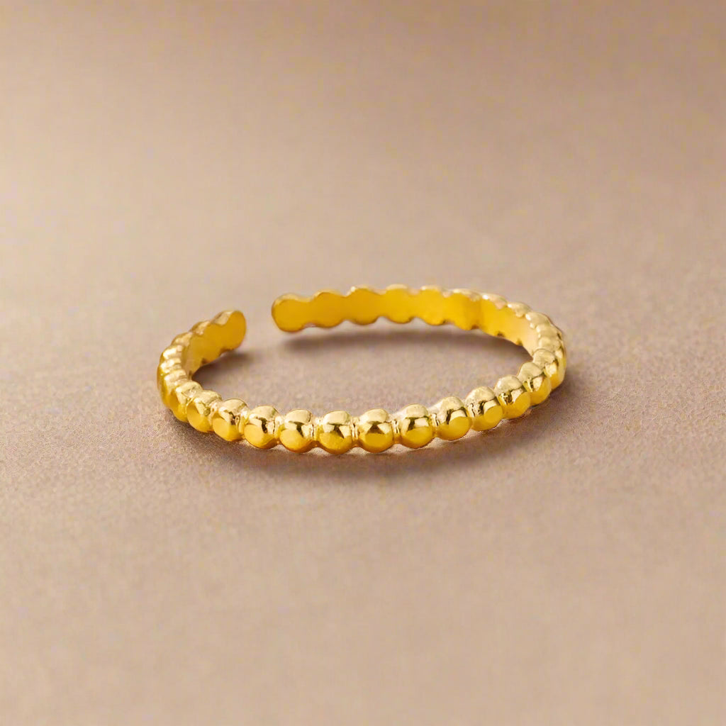 Close-up of gold beaded ring with adjustable band