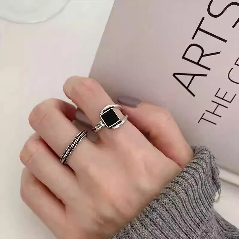 Close-up of black stone silver statement ring on white background