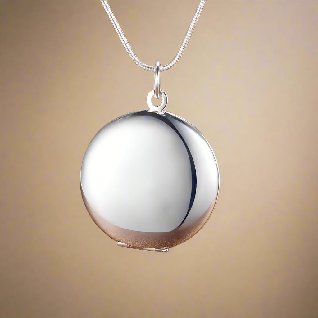 Sterling silver pendant displayed on a textured background.