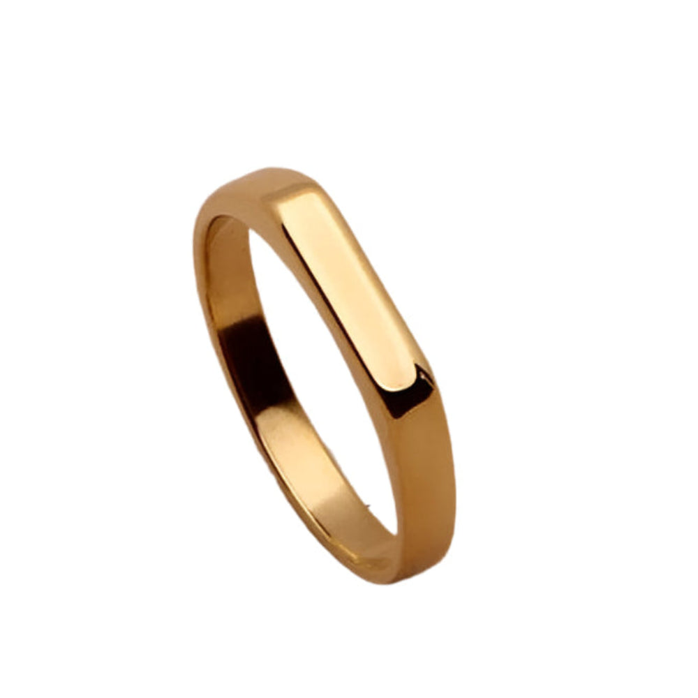 Minimalist gold ring on smooth surface