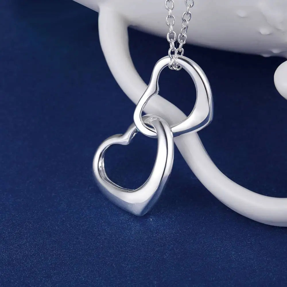 Close-up of intertwined heart design in shiny silver. 
