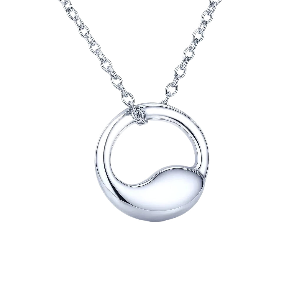 Minimalist silver pendant displayed elegantly on a surface.