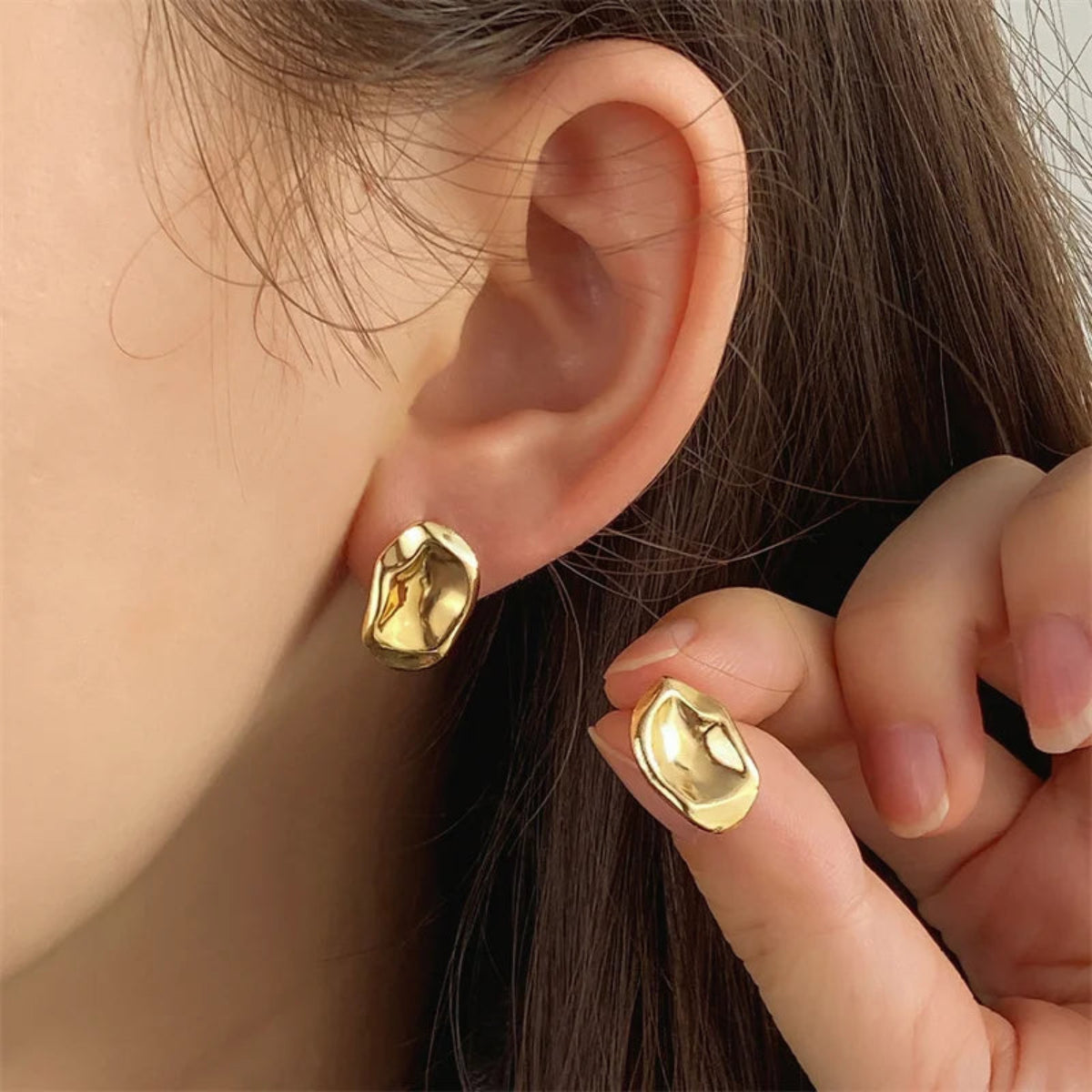 Molten Metal stud earrings in high-shine silver finish on white background