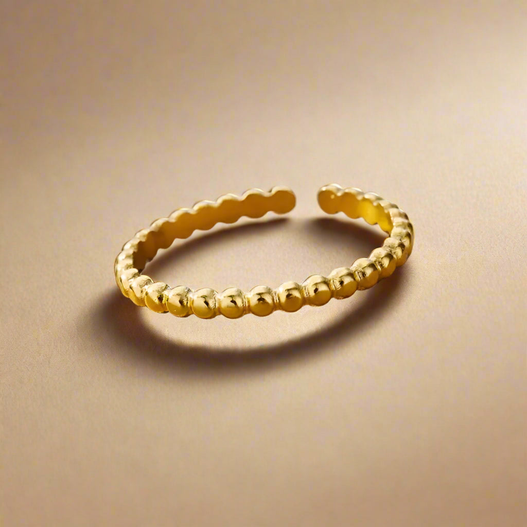 Side view of gold-plated, beaded open ring.