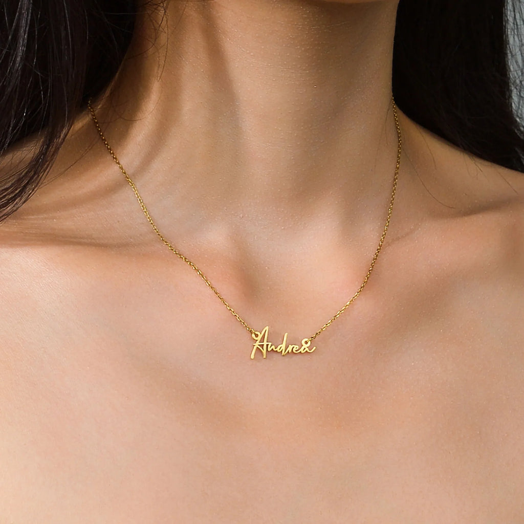 Elegant script necklace in polished gold finish.