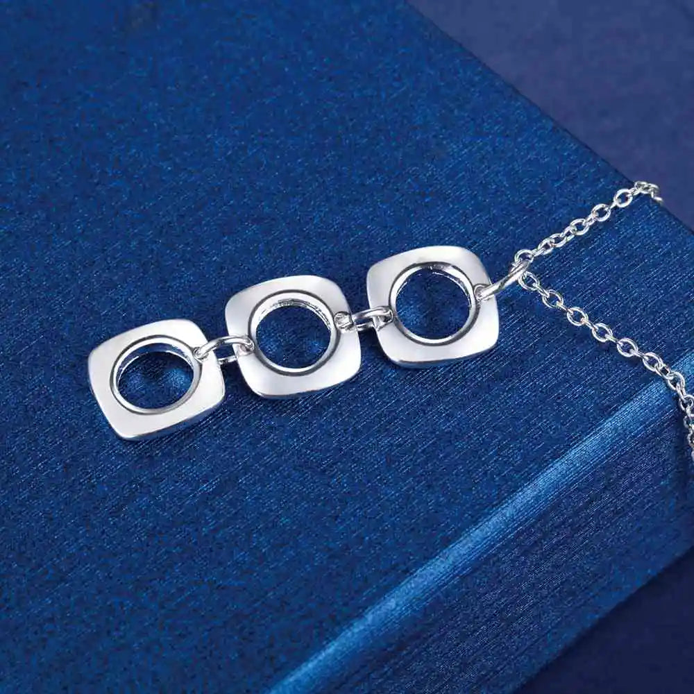  Elegant necklace with three interlocked silver squares.