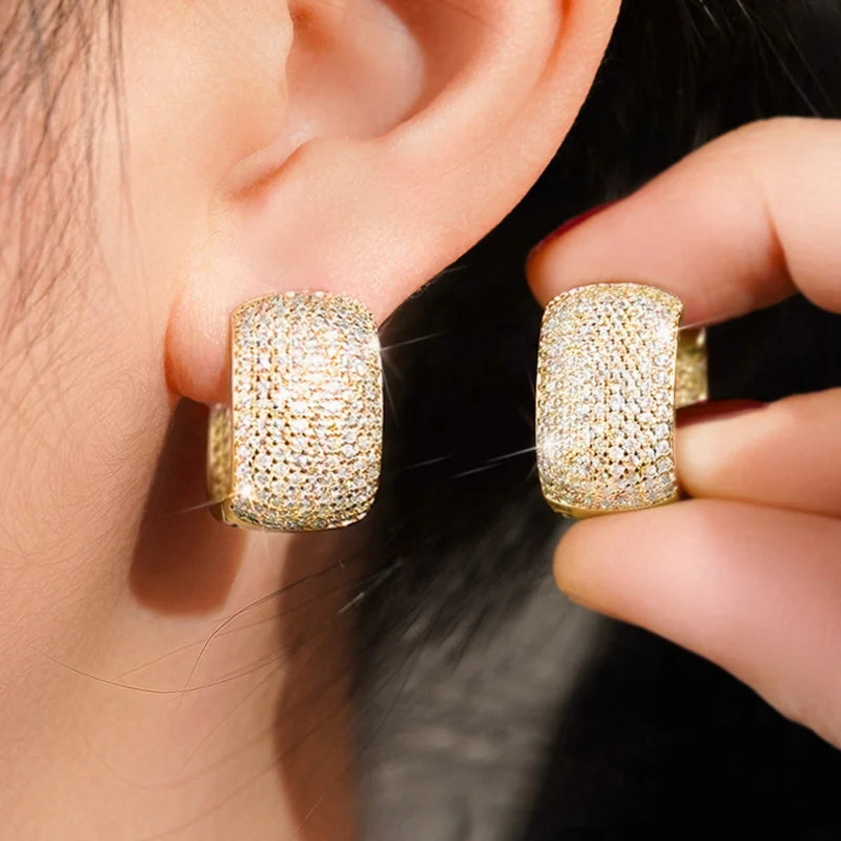 Close-up of silver and gold cubic zirconia earrings