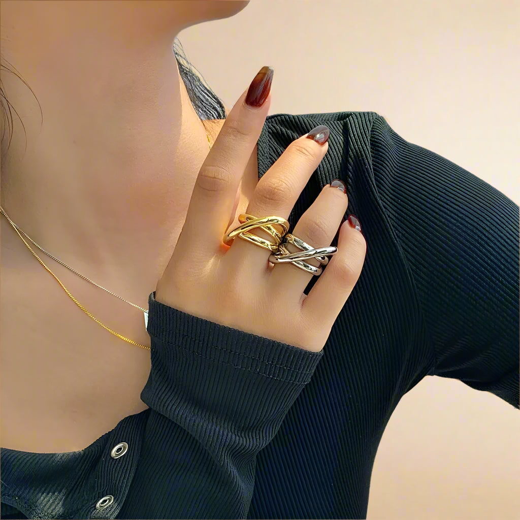 Chic gold stainless steel ring with sleek, intertwining bands.