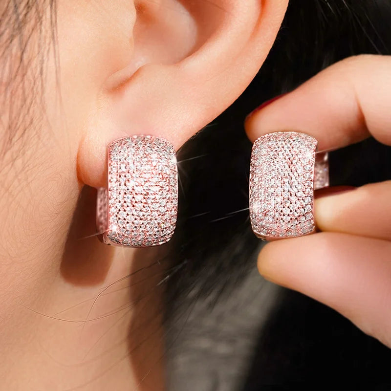 Close-up of silver and gold cubic zirconia earrings