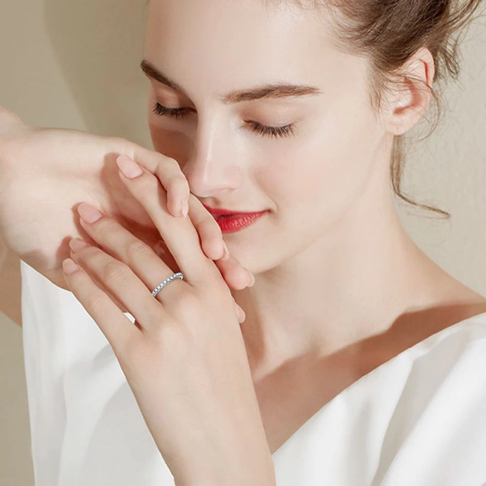 Model wearing moissanite ring on index and ring fingers – minimalist elegance