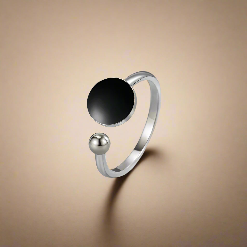 Close-up of black glazed stainless steel open ring 